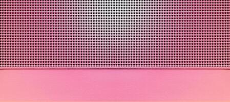 Spot lit perforated pink metal plate photo