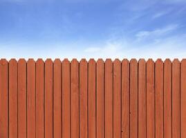 Fence wooden parallel bars, painted brown. photo