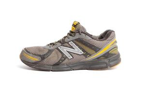 Dirty old New Balance 470 v3 running trainers with holes in on a white background photo