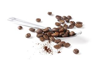 Spoon with coffee beans, macro photo. photo