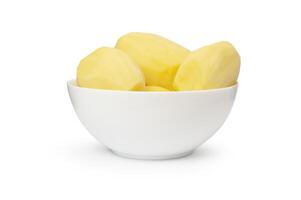 Peeled potatoes in a white bowl isolated on white background photo