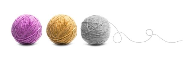 Different color balls of threads wool yarn isolated on white photo