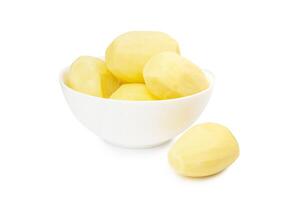 Peeled potatoes in a white bowl isolated on white background photo