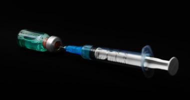 syringe isolated on black background photo