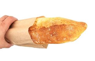 Freshly baked baguette in a paper package photo