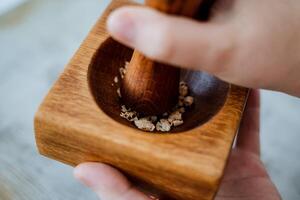 stupa made of wood, shot close-up, chop grass spices, hold in hands photo