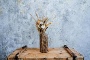 a vase with dried flowers photo