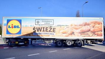 Warsaw, Poland. 16 February 2024. Sign Lidl. Company signboard Lidl. Lidl truck delivering food and goods to the discount supermarket. photo