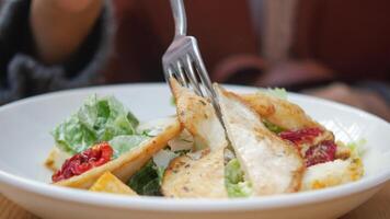 Grilled chicken and fresh vegetable salad on table. video