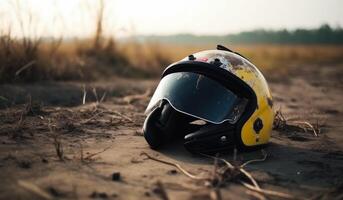 AI generated Yellow motorcycle helmet lying on the sand in the evening photo