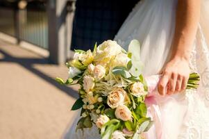 Bouquet of flowers for the bride. Beautiful wedding bouquet in hands of the bride photo