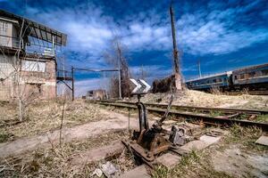 Abandoned railway station . Rusty weathered peeled paint of an old wagon. Blue railway carriage. photo