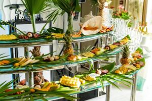 Brightly decorated buffet with different exotic fruits for guests outdoors. Assorted delicacies of exotic fruit, restaurant food at event. photo