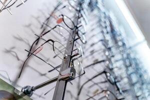 A rack of eyeglasses in shop. Showcase with spectacles in modern ophthalmic store. photo