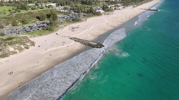 white sand turquoise sea people walking city beach perth australia aerial 4k video