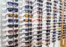 Sales rack of sunglasses. A colorful display of sunglasses for sale photo