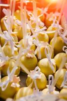 Delicious sweet cake-pops with silk ribbons on a festive table. Tasty cake pops on plate, close up. photo