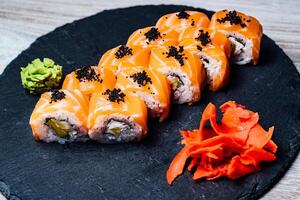 Sushi roll in japanese restaurant. Sushi Set and sushi rolls served on stone slate photo