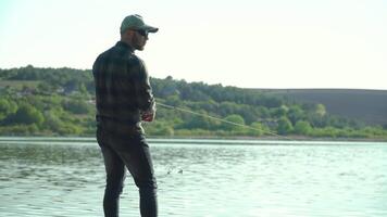 pescatore getto pesca asta nel lago o fiume acqua. Filatura pesca predatore pesce video