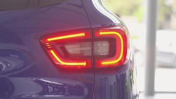 Details of switched on tail lights of anonymous prestigious luxury modern car. Concept of passion for driving cars and engines video