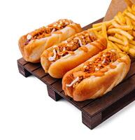 Hot dogs and fried potatoes on wooden board photo