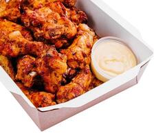 Fried chicken wings and legs in a paper box photo
