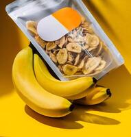 Pack of dried bio organic healthy banana chips photo