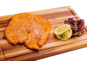 Schnitzel with salad on a board photo