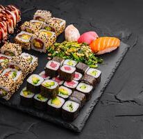 Sushi set on black stone background photo
