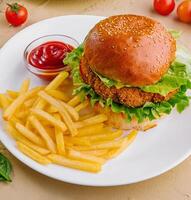 burgers with french fries served on plates photo