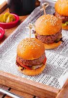 mini burgers close up on wooden tray photo