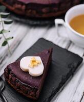 Sacher cake slice and tea on wood photo