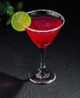 martini glasses of red alcohol drink on stone photo