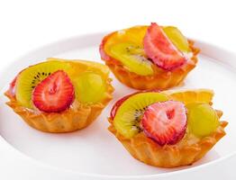 Mini tarts with cream and mix of summer fruit photo