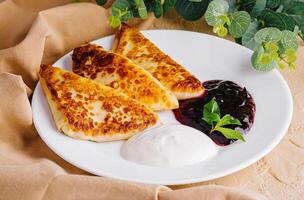 Pancakes with sour cream and jam photo