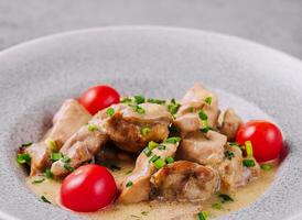 Grilled chicken breast with cream sauce and tomatoes photo