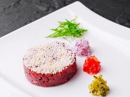 Chopped beef, steak tartare served and pickles photo