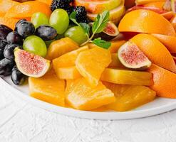 Exotic fruits platter isolated on white photo