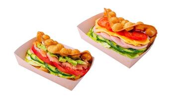 Belgian waffles with salmon, ham, avocado and salad on boxes photo