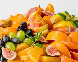Exotic fruits platter isolated on white photo