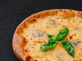 fresh tasty four cheeses pizza on wood photo