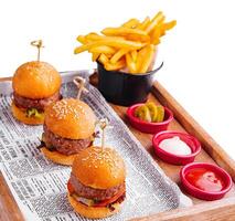 mini burgers with fries on wooden tray photo