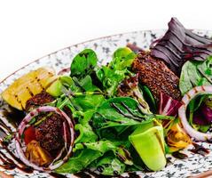 healthy green salad on plate isolated photo