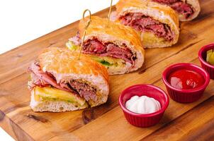 Mini sandwiches with ham and sauces photo