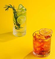 Cocktail Negroni and mojito cocktail on yellow background photo