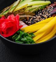 bowl with mango, cucumber and eel in unagi sauce photo