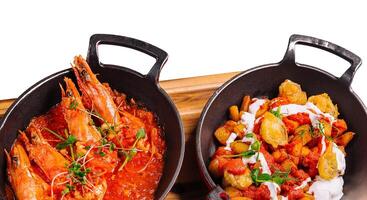 freshly cooked prawns in spicy tomato sauce and fish in batter photo