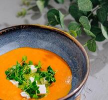 Pumpkin soup with pesto top view photo