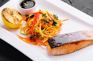 grilled salmon fillet steak with vegetable salad photo