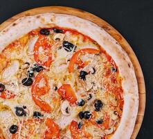 Pizza with chicken, tomato and mushrooms photo